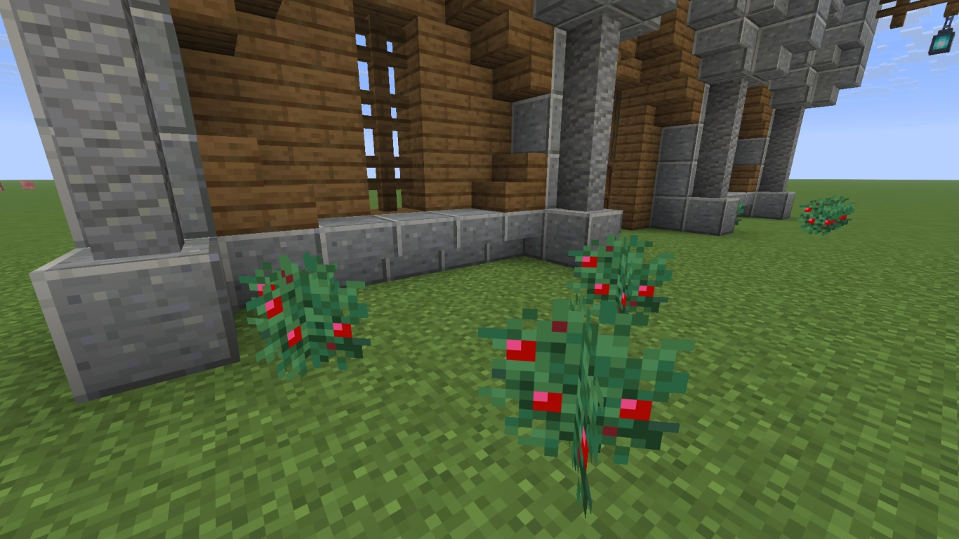 Traps and damaging blocks in front of a Minecraft wall, including magma blocks and sweet berry bushes